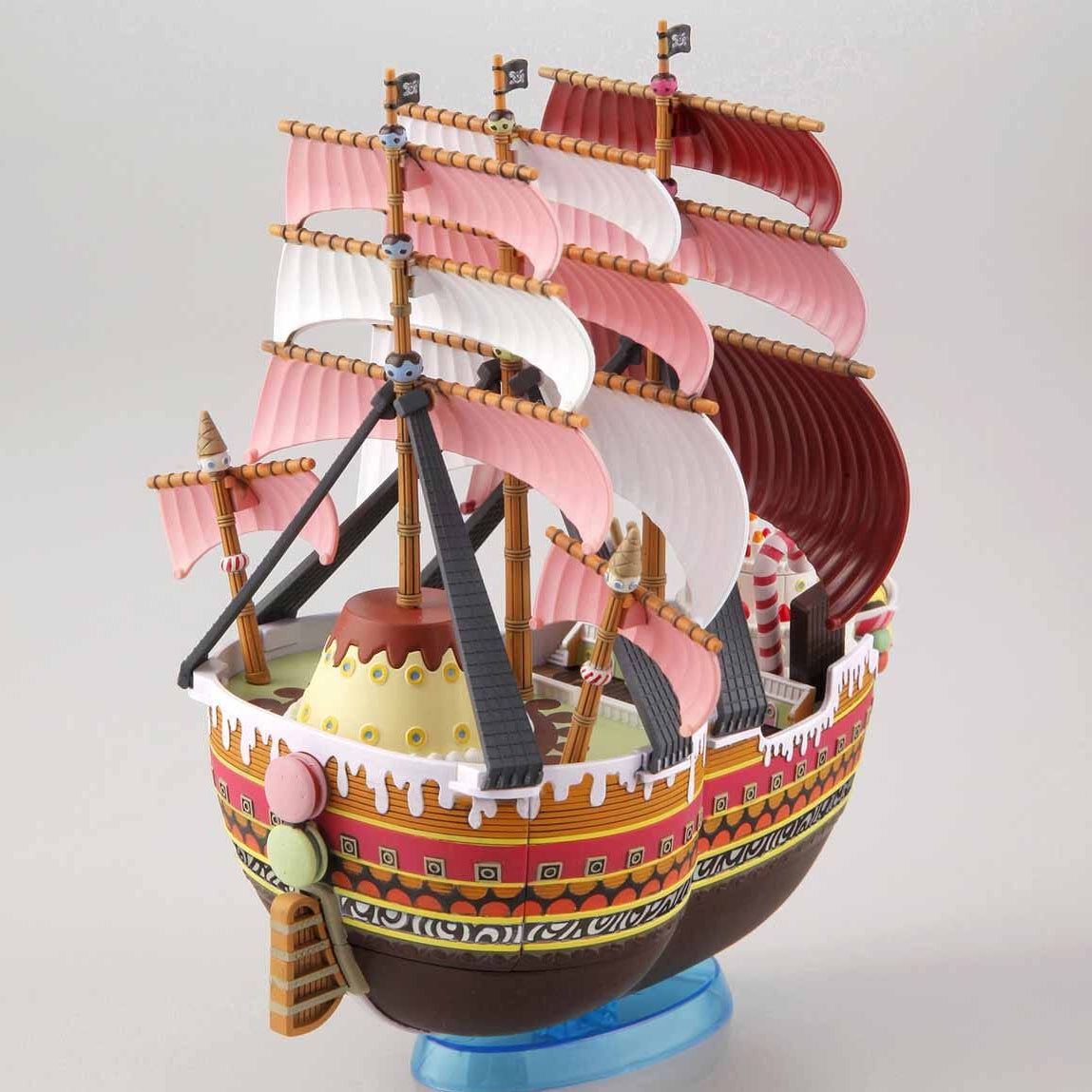 Model ship with pink sails on a white background