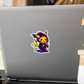 Laptop with a horse sticker on a desk with a plant and pen in the background