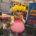 Toy figure of a character with yellow hair and pink outfit in a store setting