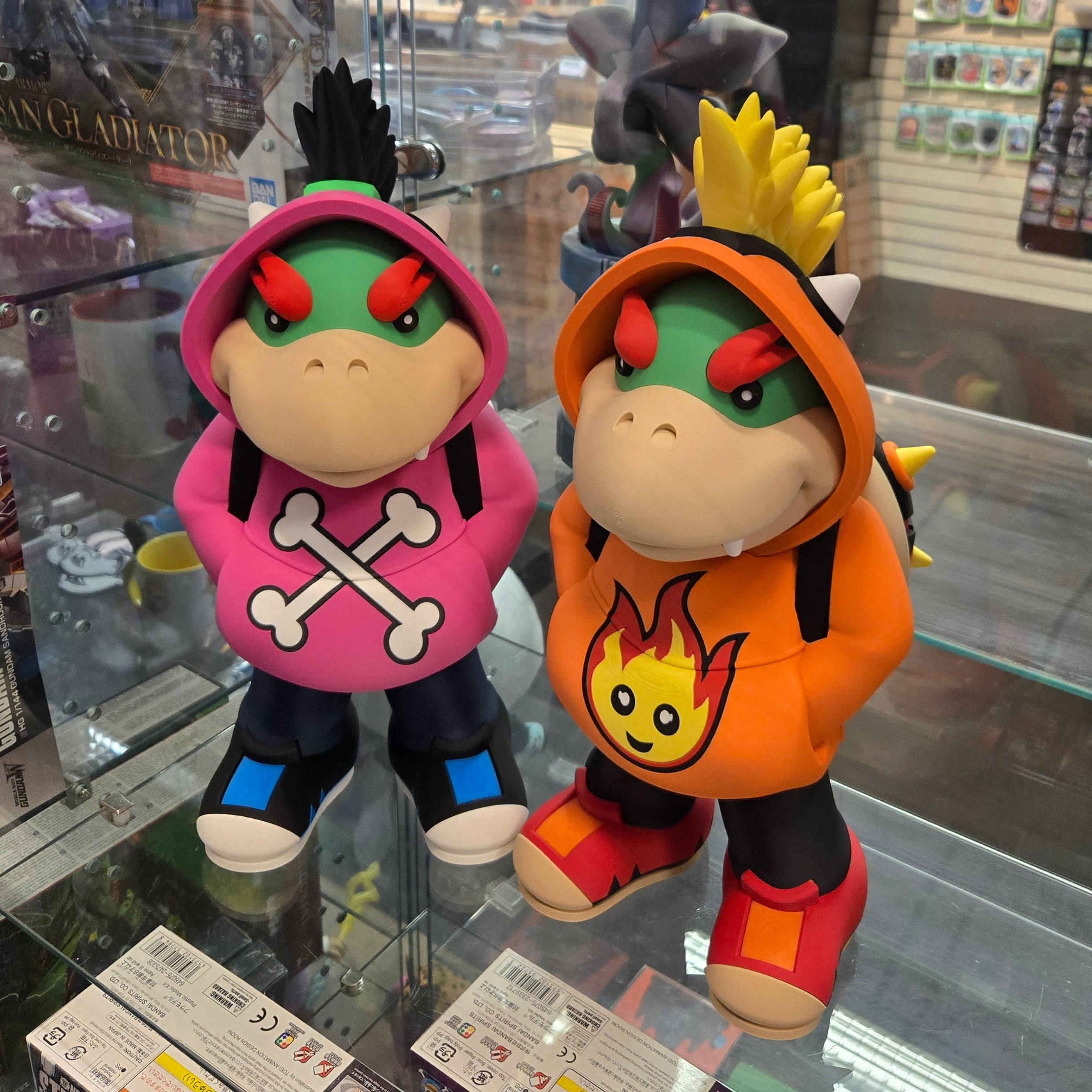 Two colorful plush toys on a reflective surface with a store interior in the background