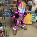 Colorful action figure in a store setting with shelves and toys in the background