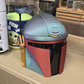 Colorful helmet on a stand with a store interior in the background