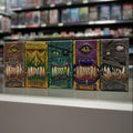 Five colorful monster mouth boxes with different designs on a reflective surface.