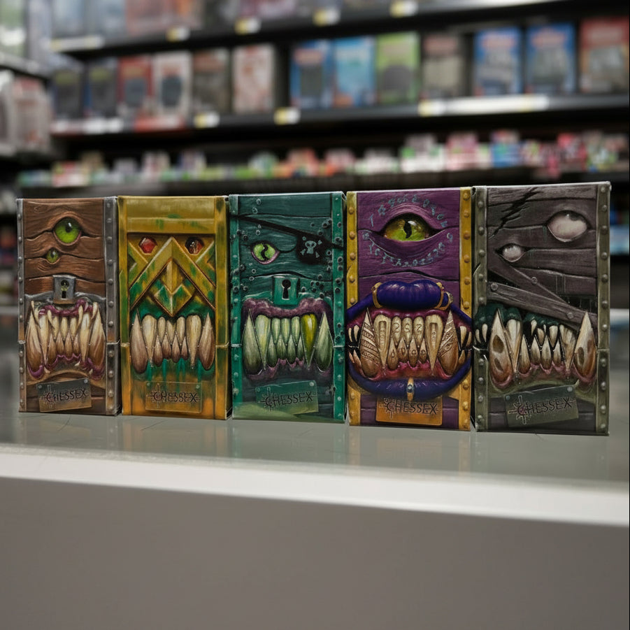Five colorful monster mouth boxes with different designs on a reflective surface.