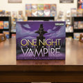 Board game box for 'One Night Ultimate Vampire' with a dark figure against a purple night sky.