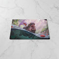 Fantasy illustration of a hippo-like creature with purple wings rising from water, surrounded by lotus flowers and a misty forest background. A visible artist signature/watermark appears in the lower-left corner.