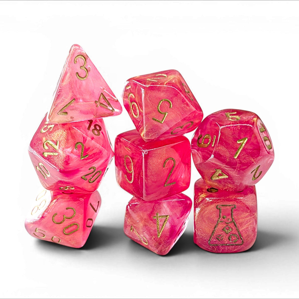 A set of translucent pink polyhedral gaming dice with gold-colored numbers and symbols, arranged on a clean white background.