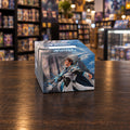 A Magic: The Gathering collectible card box featuring artwork of a blue-skinned female wizard character in a white and blue robe against a cloudy sky, photographed on a clean light gray studio background.