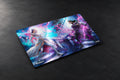 A rectangular gaming mouse pad with rounded corners, featuring a vibrant fantasy illustration of two characters in combat with purple and blue energy effects. The word 'MAGIC' is printed near the bottom left corner, and a copyright notice for Wizards of the Coast is visible in the bottom-left corner of the image.