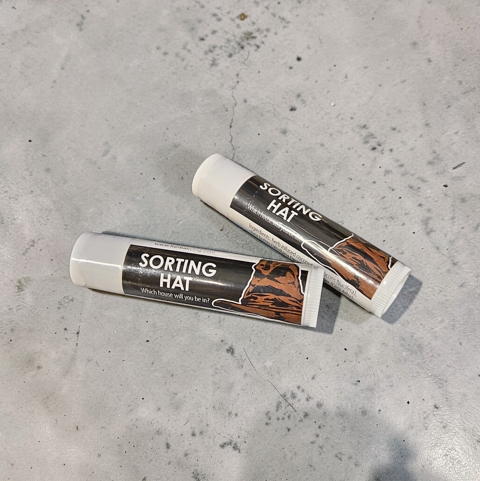 Two 'Sorting Hat' products on a gray concrete surface