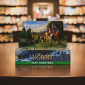 Card game booster pack featuring 'The Hobbit' and 'Magic: The Gathering' with fantasy artwork.