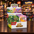 Pokémon Trading Card Game 30th Celebration display box showing multiple colorful booster pack tins with illustrated character art and the Pokémon logo on a white background.