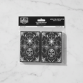 Pack of card sleeves with white black mana design on a white background