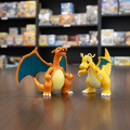 Two dragon-like toy figures on a white background