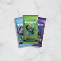 Three 'Magic: The Gathering' trading card game booster packs on a white background.
