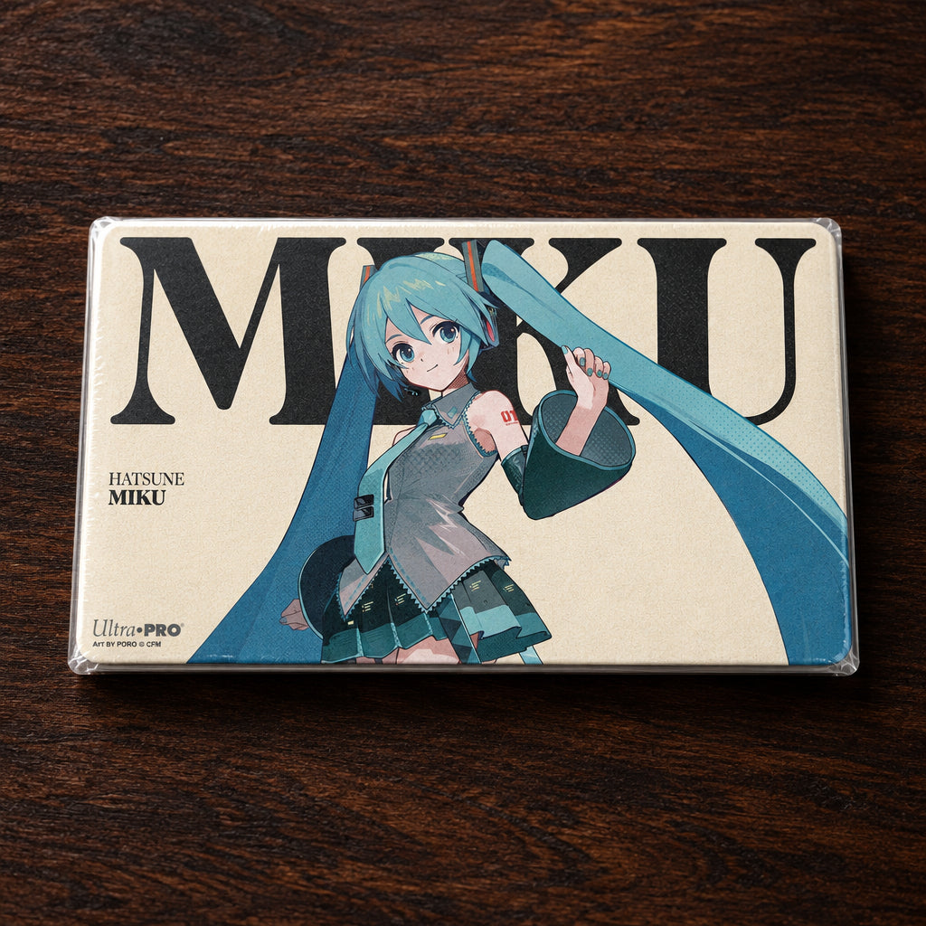 A rectangular Ultra PRO playmat featuring Hatsune Miku. The design shows a stylized illustration of Miku with her signature teal twin-tails flowing behind her, set against a cream-colored background with large black 'MIKU' lettering.