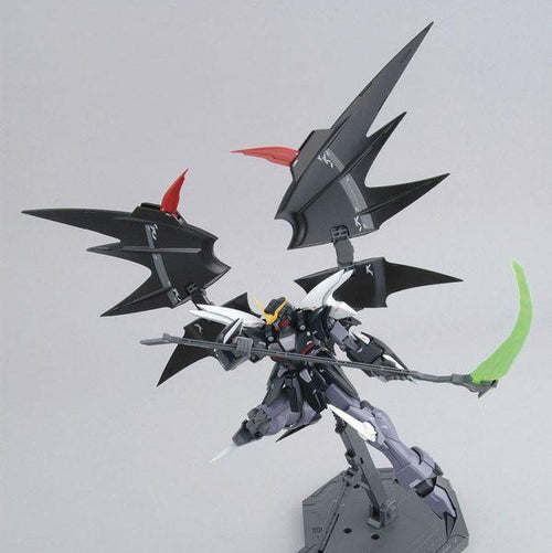 Model kit of a black and gray robot with red accents on a white background, featuring the Sotsu and Sunrise logos.