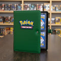 Green Pokémon trading card holder with cards inside on a white background