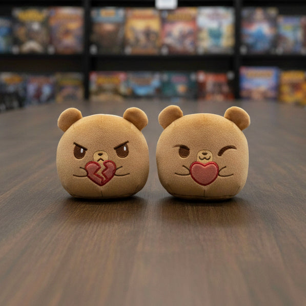 Two brown plush toys with facial expressions on a white background