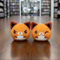 Two orange plush toys with fox-like designs on a white background