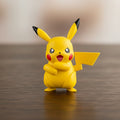 Yellow Pikachu figure with red cheeks and black ears on a white background