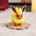 Figurine of a Pokémon character on a wooden stand with candles in the background